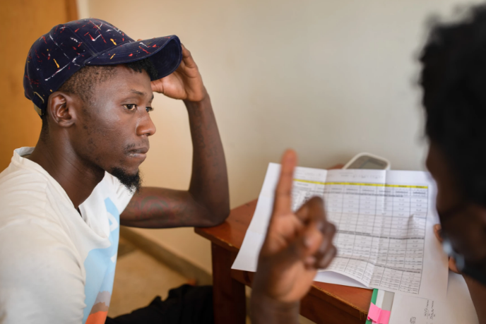 A nurse enrolls a participant in an HIV vaccine trial in Masaka, Uganda, an African-led project.